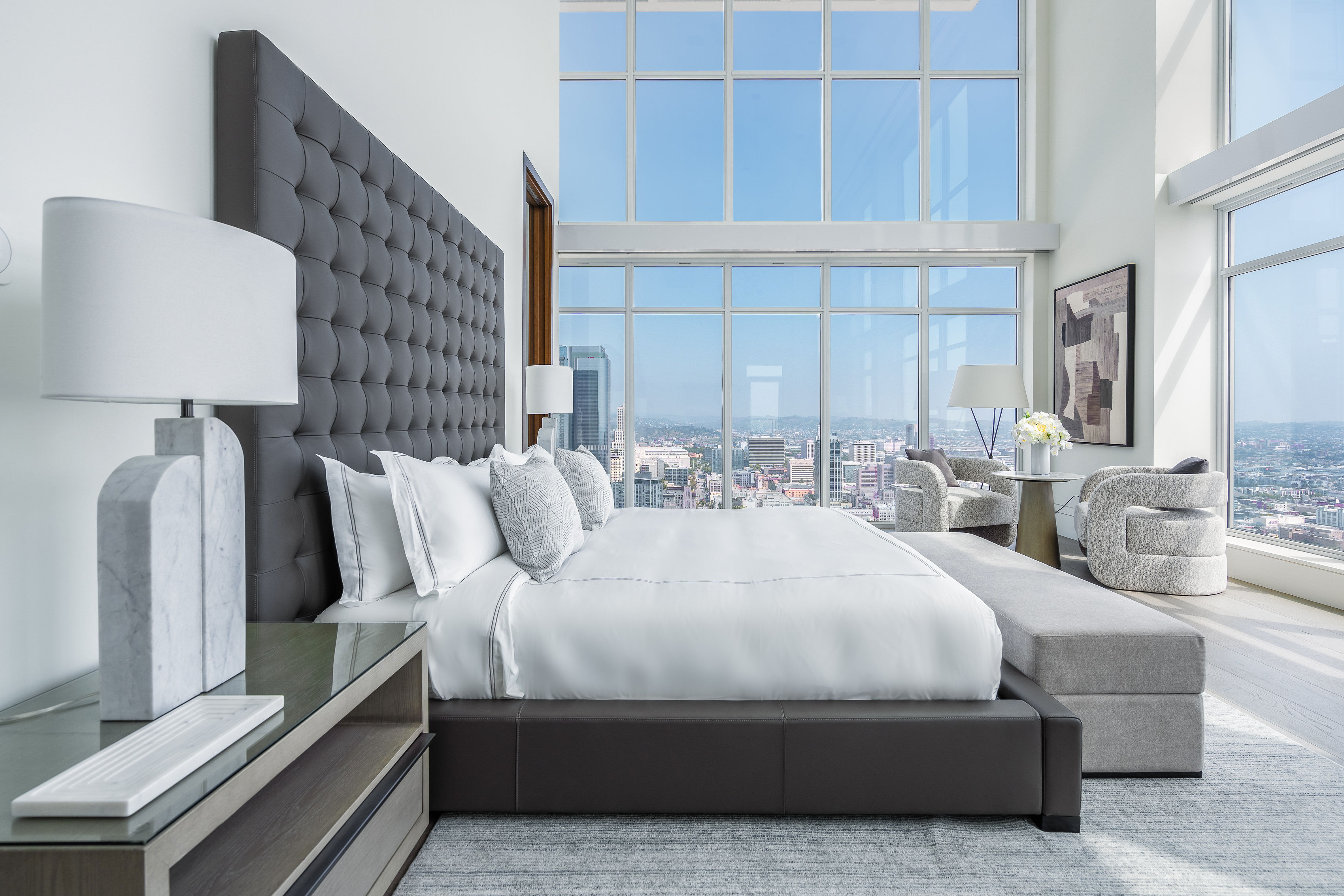 825 S. Hill primary bedroom suite with double-height city view windows