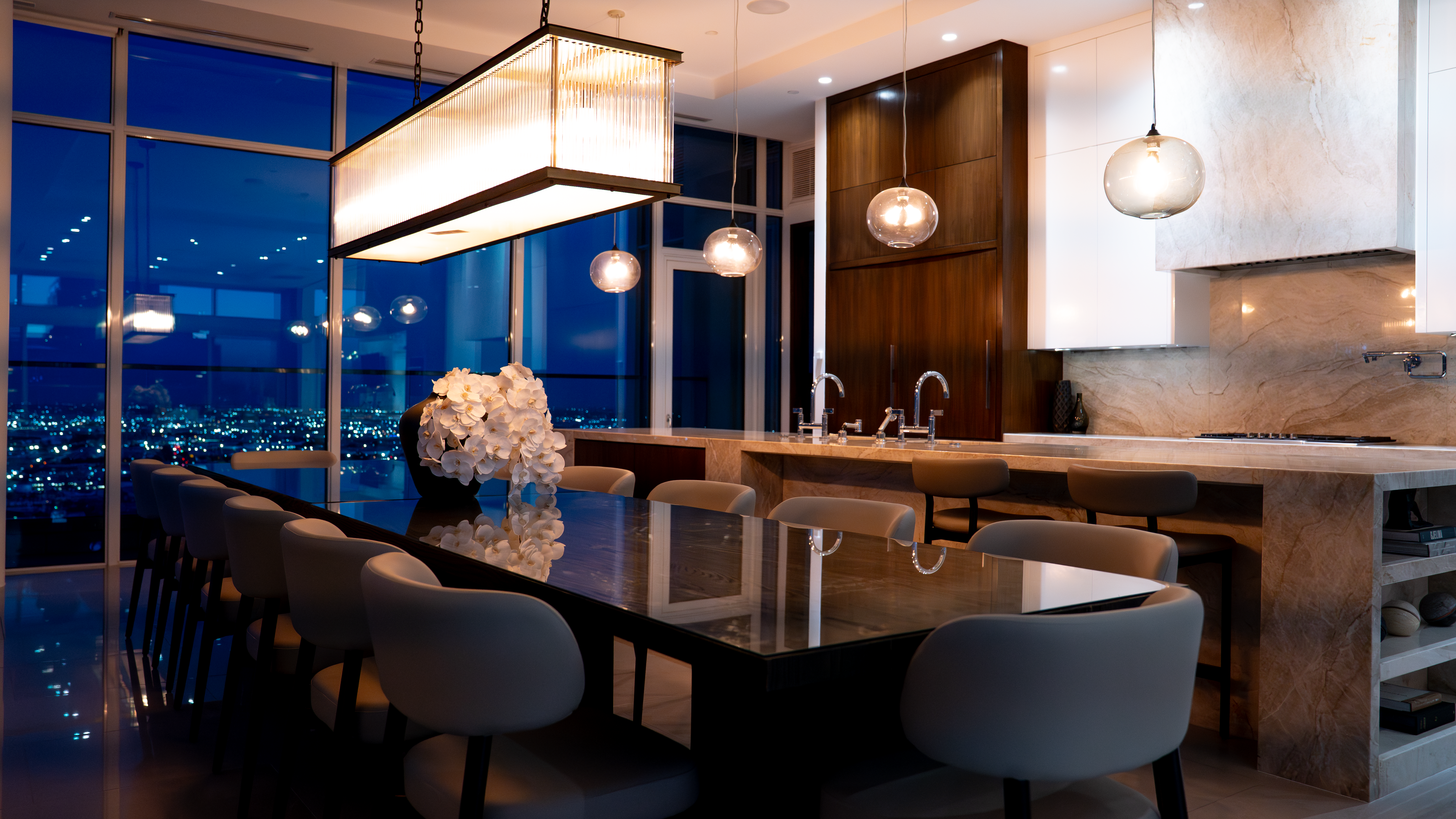 888 S. Olive dining and kitchen at night with city lights