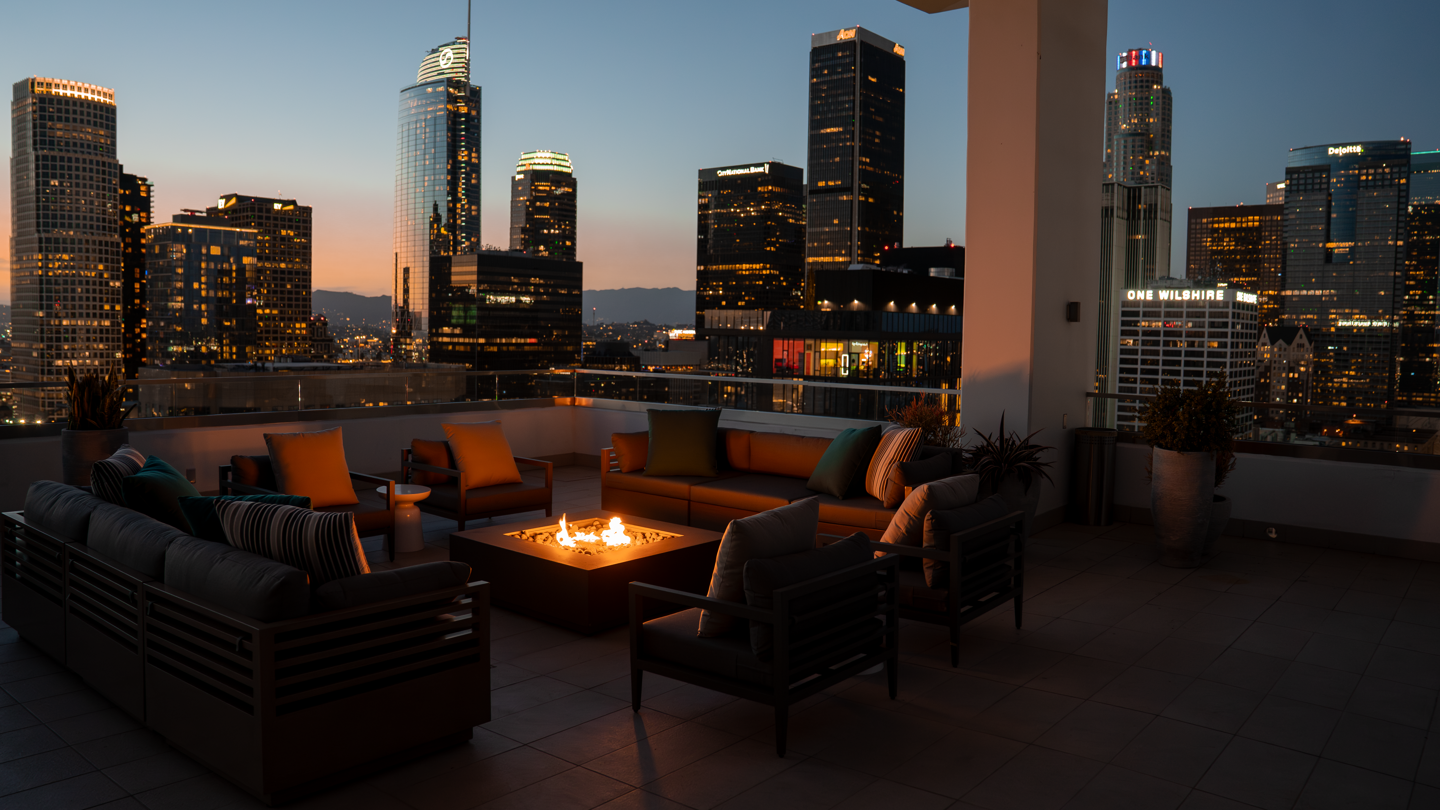 888 S. Olive rooftop fire-pit lounge with skyline at night