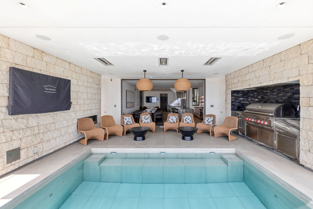 Pool interior with stone walls and outdoor kitchen
